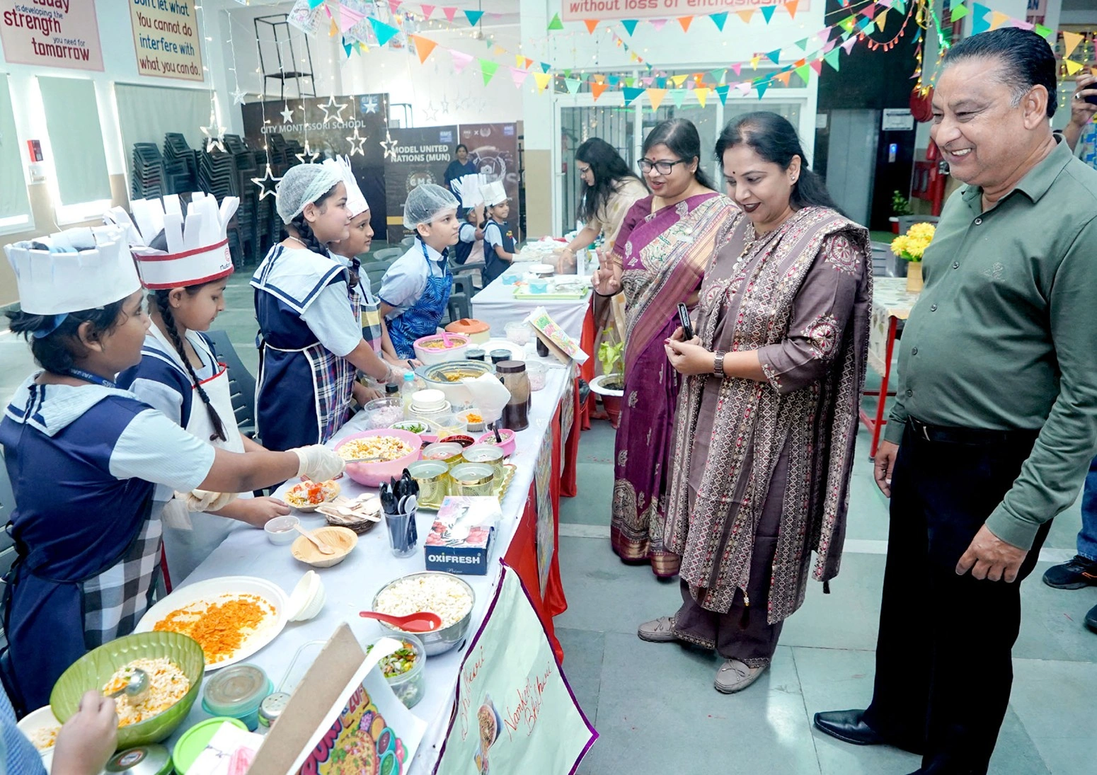 The chief guest, along with the principal, staff, and CMS students, at the inauguration of the Activity Centre at City Montessori School, Asharfabad Campus, viewing students activities at the Project-Based Learning exhibition.