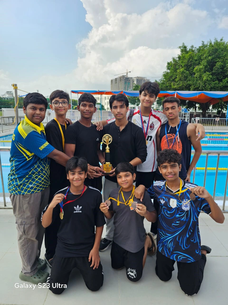 Passionate Swimmers of CMS Rajendra Nagar I with their medals and trophy, following the result announcement
