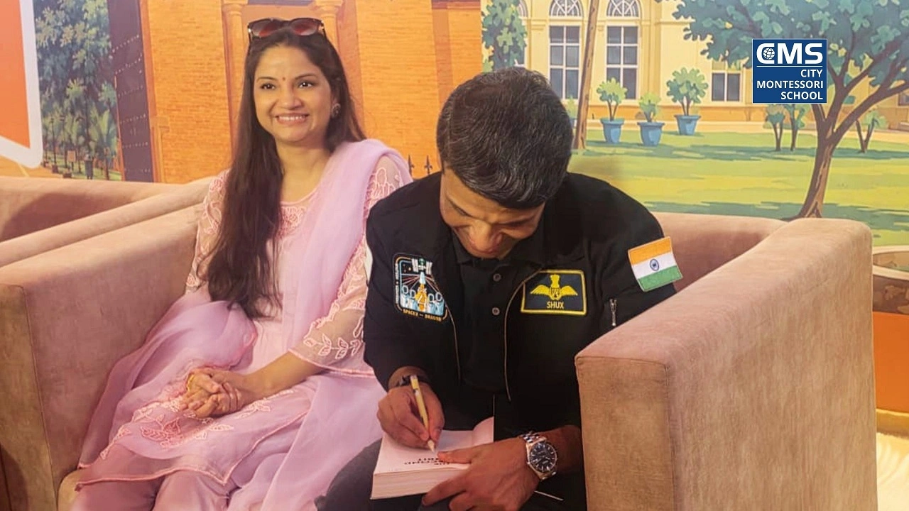 Group Captain Shubhanshu Shukla ‘Shux’ signs a copy of his book, ‘The Second Orbit’, accompanied by his wife, Dr Kamna Shukla, at the 5th Gomti Pustak Mela in Lucknow.