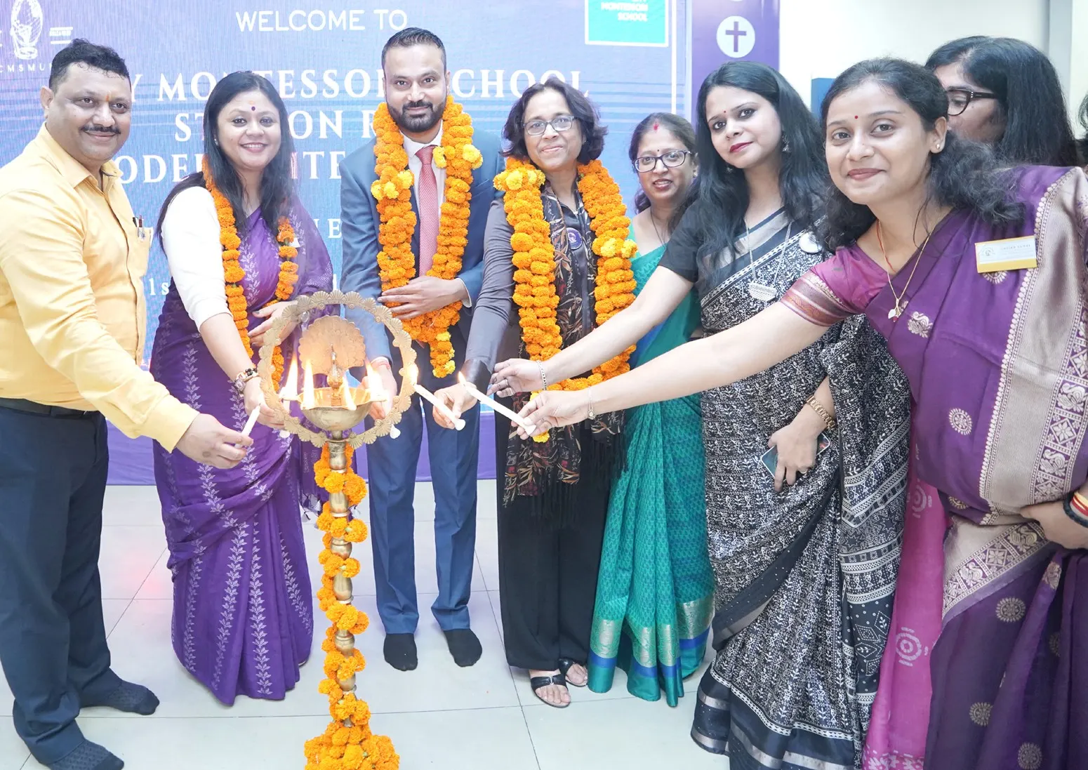Chief Guest Mr Atul Kumar Rawat, Company Secretary and Former Chairman of NIRC of ICSI (Lucknow Chapter), along with Prof. Geeta Gandhi Kingdon, Managing Director, CMS (left), and Principal and Convenor Ms Junu Thakur Bisht, lights the lamp of learning alongside members of the Model United Nations (MUN) organizing committee.