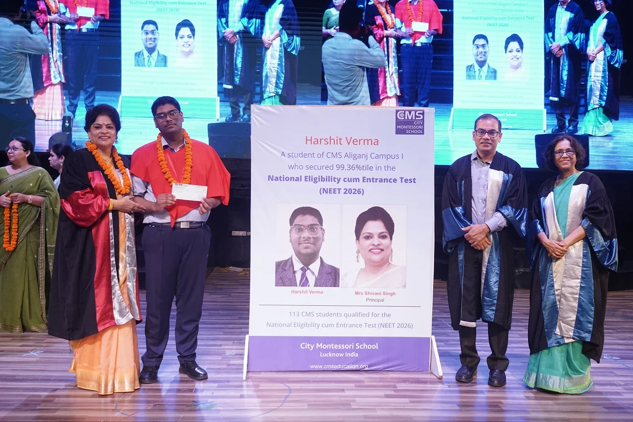 NEET 2026 Topper from the CMS JJ Section being presented with a cash prize of INR 1 lakh by Chief Guest Shri Alok Kumar, IAS, Principal Secretary, IT & Electronics Department, Government of Uttar Pradesh, and CMS Managing Director Prof. Geeta Gandhi Kingdon